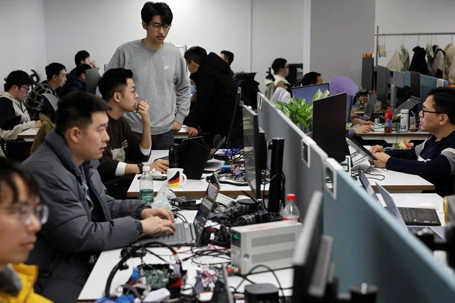 Employees work in an office in Hefei, Anhui province, China, on 4 February 2026. (Florence Lo/Reuters)