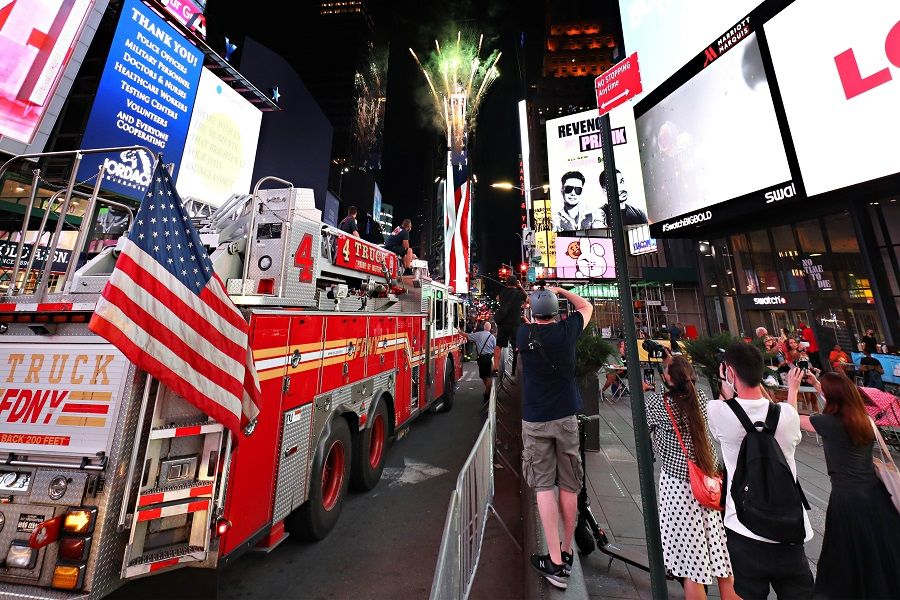 People watch as fireworks are launched in Times Square as part of the annual Macy's 4th of July Fireworks on 1 July 2020 in New York City. (Cindy Ord/Getty Images/AFP)