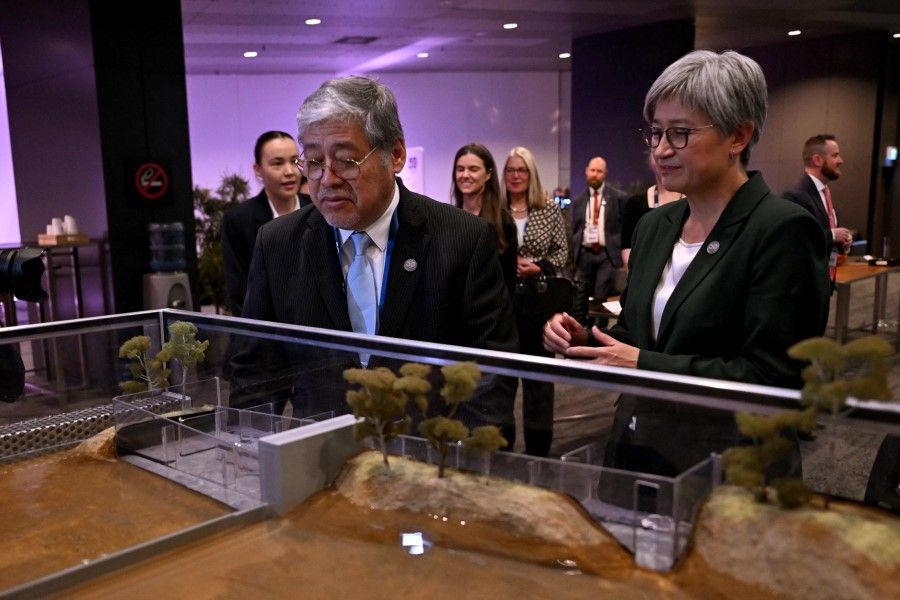 Australia's Foreign Minister Penny Wong (right) and Philippines' Foreign Secretary Enrique Manalo (left) inspect a display before the opening of the Australia-ASEAN (Association of Southeast Asian Nations) summit in Melbourne on 4 March 2024. (Photo by William West/AFP)