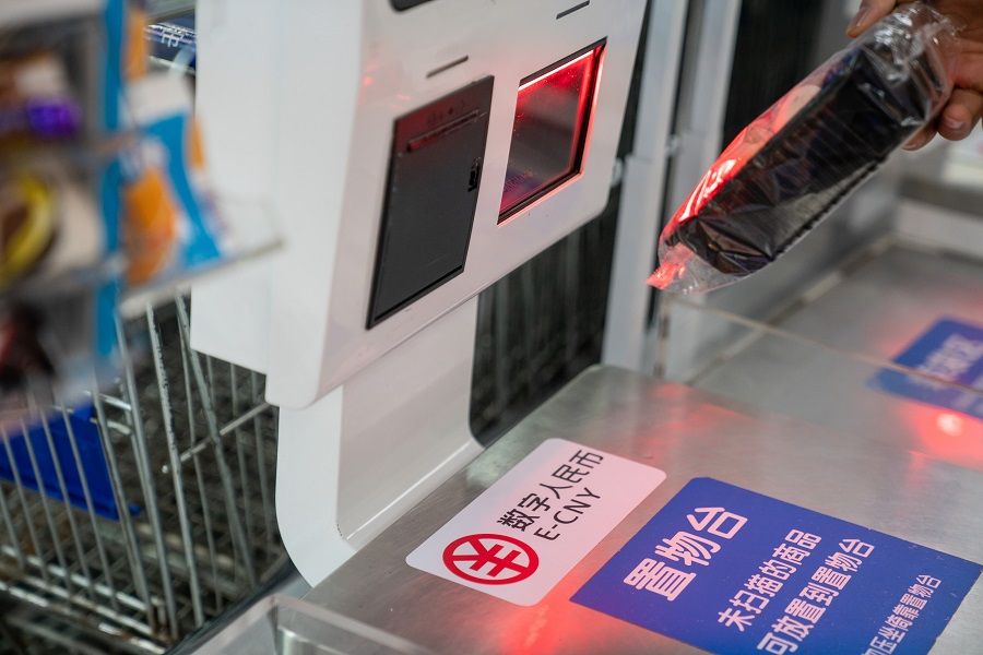 Signage for the digital yuan, also referred to as E-CNY, at a self check-out counter inside a supermarket in Shenzhen, China, on 20 November 2020. (Yan Cong/Bloomberg)
