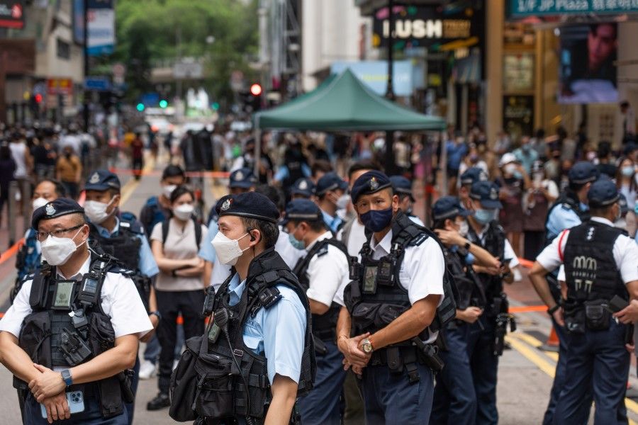 Police officers stand guard at the Causeway Bay area outside Victoria Park, the traditional site of the annual Tiananmen candlelight vigil, in Hong Kong, China, on Saturday, 4 June 2022. (Bertha Wang/Bloomberg)
