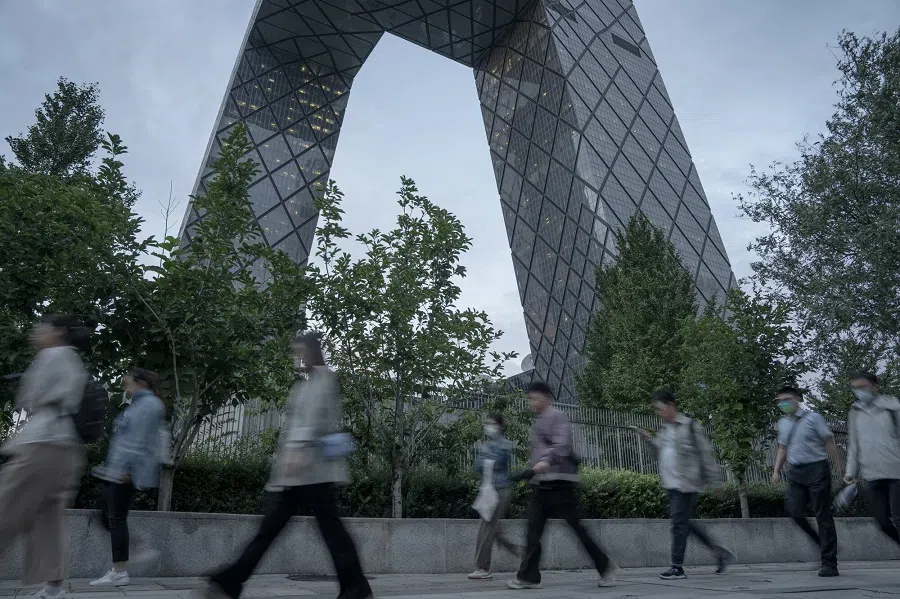 Pedestrians walk past the China Central Television (CCTV) Tower in Beijing, China, on 20 September 2024. (Na Bian/Bloomberg)