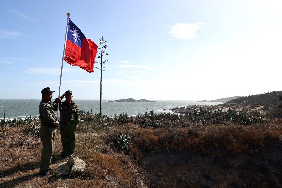 Veterans take part in a flag raising ceremony at a former military post on Kinmen, Taiwan, 15 October 2021. (Ann Wang/Reuters)