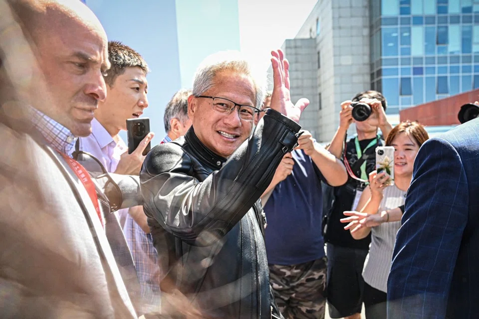 Nvidia CEO Jensen Huang (centre) waves to the crowd as he leaves during the China International Supply Chain Expo (CISCE) in Beijing, China, on 17 July 2025. (Jade Gao/AFP)