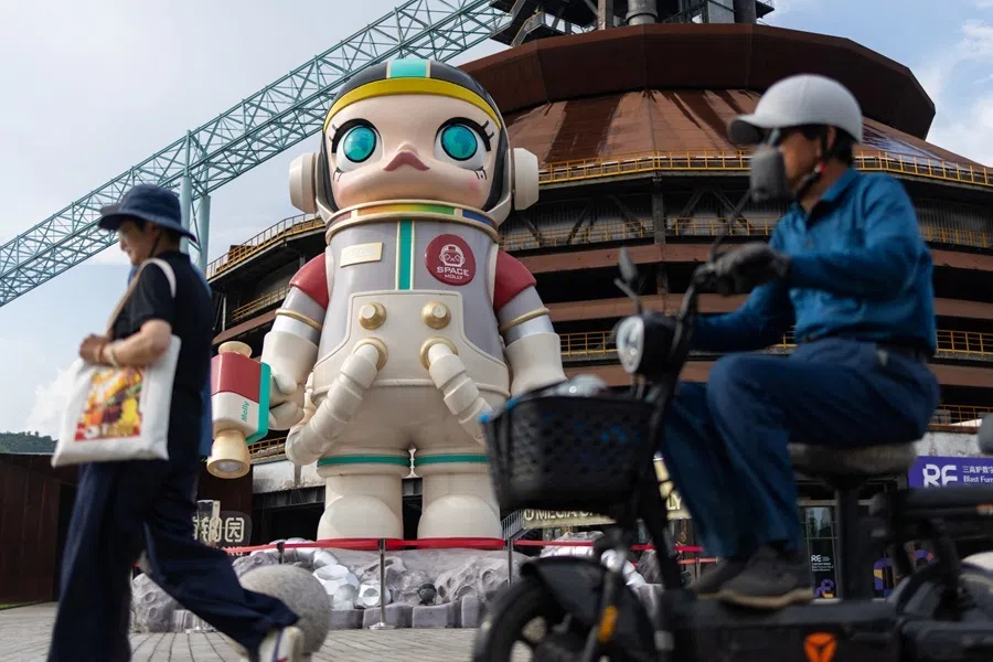 People pass by a giant figure of the Pop Mart art toy character "Space Molly" in Beijing's Shougang Park, China, 7 August 2026.