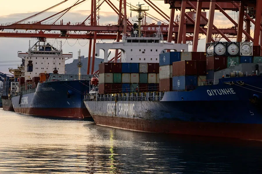 Containers are seen stacked up on berthed cargo vessels at a terminal in the southeastern port city of Busan on 24 November 2024. (Anthony Wallace/AFP)
