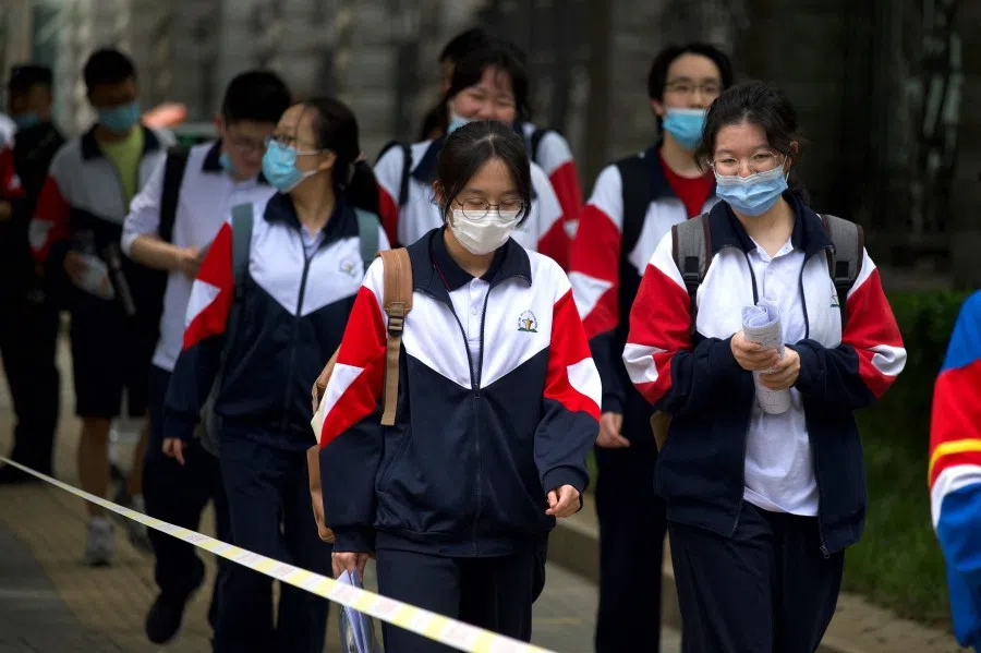 Students enter a school to sit for the first day of the National College Entrance Examination (NCEE), known as "Gaokao" in Beijing on 7 July 2021. (Wang Zhao/AFP)