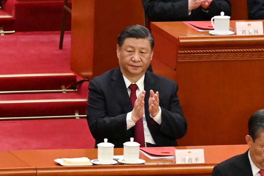 China's President Xi Jinping applauds during the closing session of the National People's Congress (NPC) at the Great Hall of the People in Beijing, China, on 13 March 2023. (Noel Celis/Pool via Reuters)