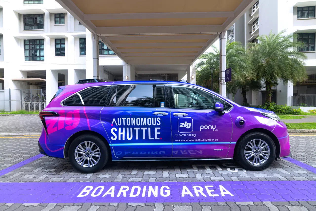 A ComfortDelGro and Pony.ai autonomous shuttle parked at a designated boarding area in Punggol, Singapore.