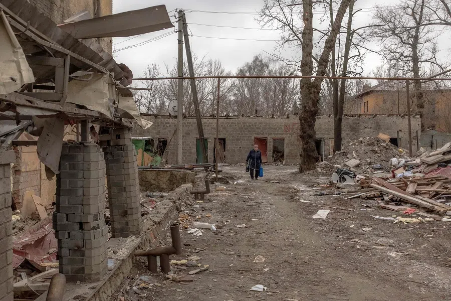 A woman walks past debris and damaged buildings after shelling in Kostyantynivka, in the Donetsk region, on 7 February 2025, amid the Russian invasion of Ukraine. (Roman Pilipey/AFP)