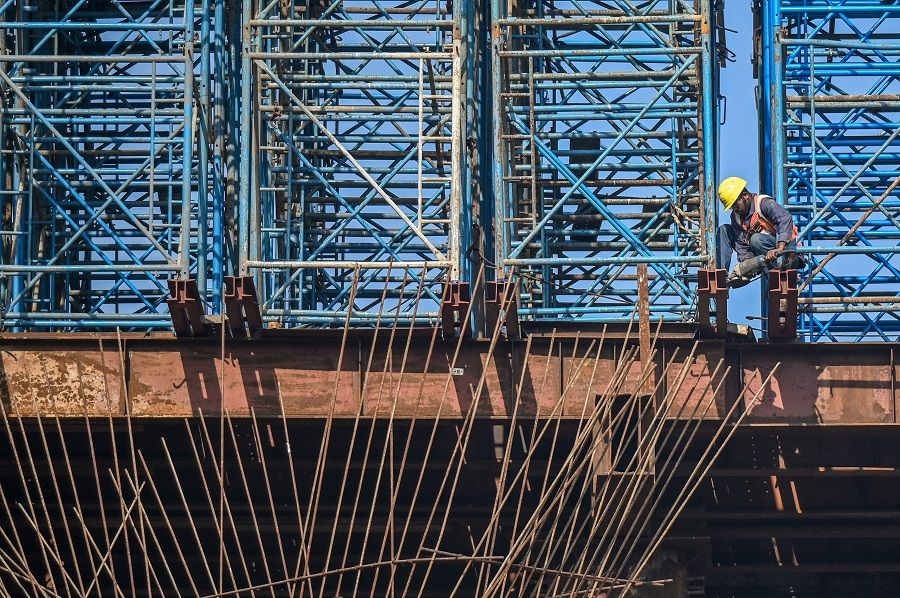 Construction personnel at work on the coastal road construction site in Mumbai, India, on 30 December 2022. (Punit Paranjpe/AFP)