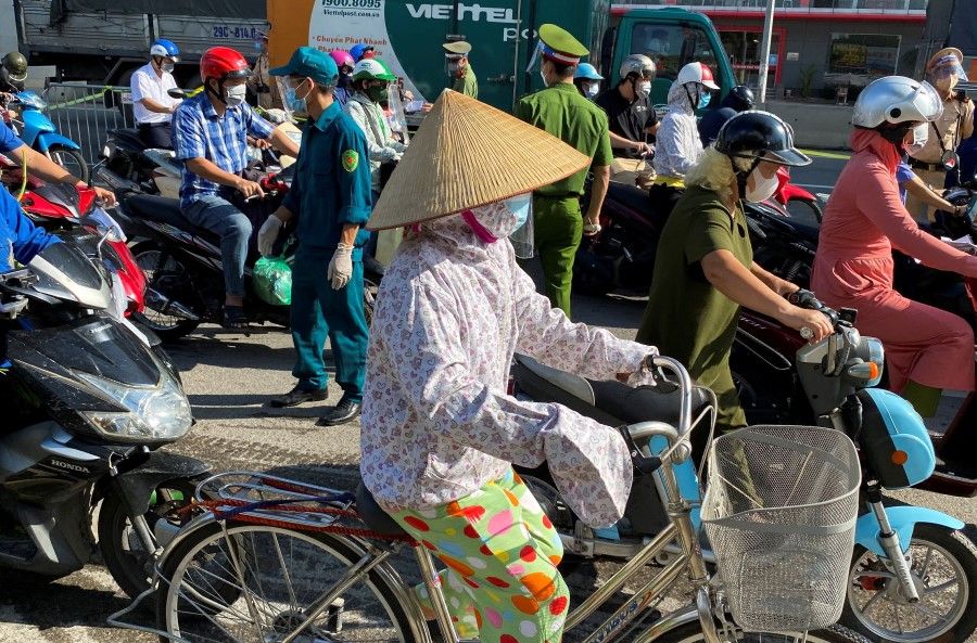 Vietnam police officers inspect commuters at a check point during the first day of the extended lockdown in Hanoi, Vietnam, 6 September 2021. (Stringer/Reuters)