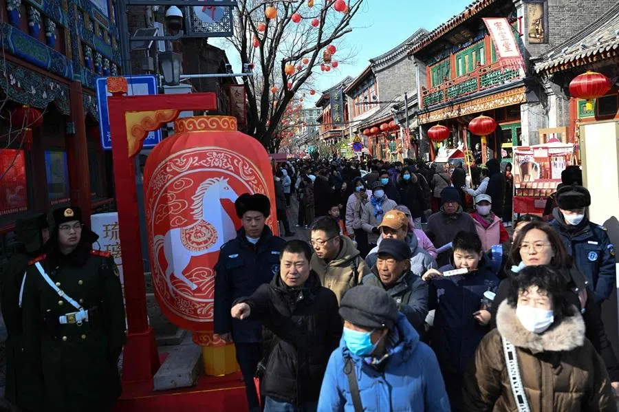 People visit a temple fair in Beijing on 22 February 2026. (Pedro Pardo/AFP)