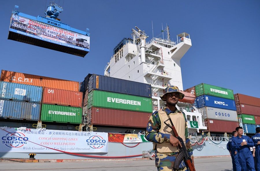 In this photograph taken on 13 November 2016, Pakistani Navy personnel stand guard near a ship carrying containers at the Gwadar port, some 700 kilometres west of Karachi, during the opening ceremony of a pilot trade programme between Pakistan and China. (Aamir Qureshi/AFP)