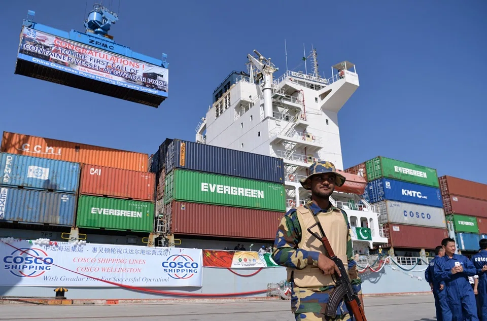 In this photograph taken on 13 November 2016, Pakistani Navy personnel stand guard near a ship carrying containers at the Gwadar port, some 700 kilometres west of Karachi, during the opening ceremony of a pilot trade programme between Pakistan and China. (Aamir Qureshi/AFP)