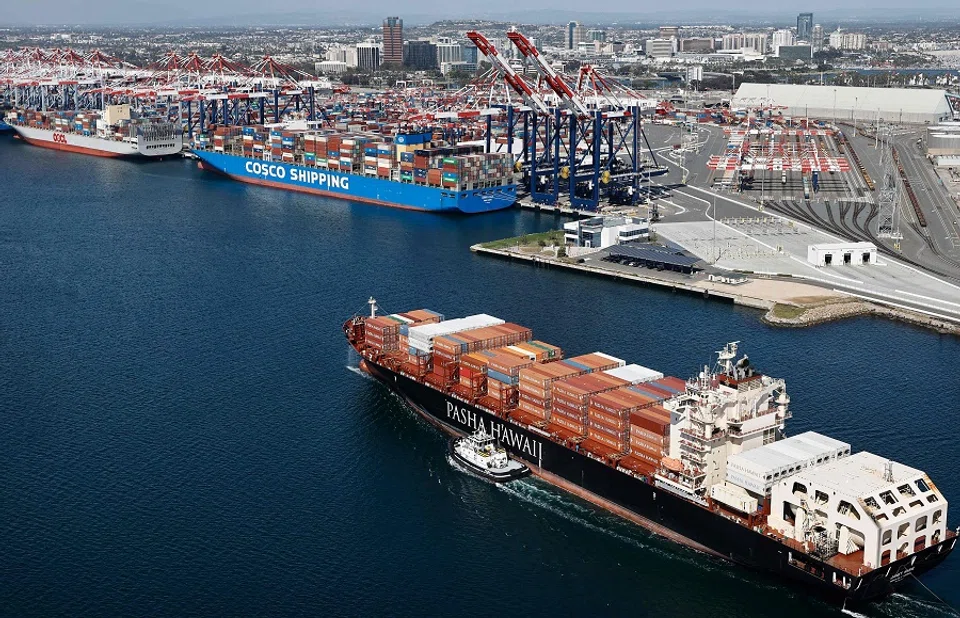 An aerial view of a Pasha Hawaii container ship arriving in the Port of Long Beach near a Cosco Shipping container ship on 3 April 2025 in Long Beach, California. (Mario Tama/Getty Images via AFP)