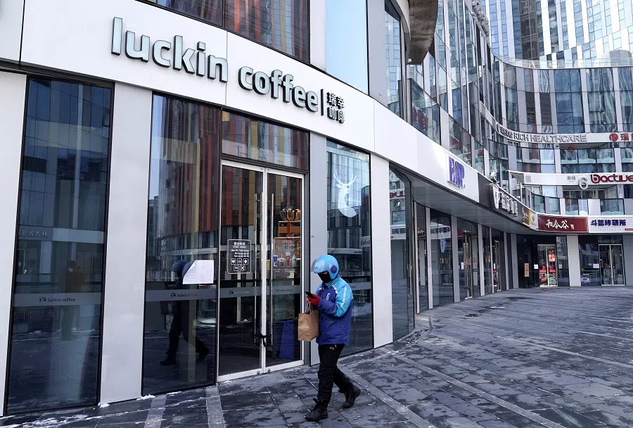 A deliveryman walks past a closed Luckin Coffee store at Sanlitun, Beijing, China on 7 February 2020. (Jason Lee/File Photo/Reuters)