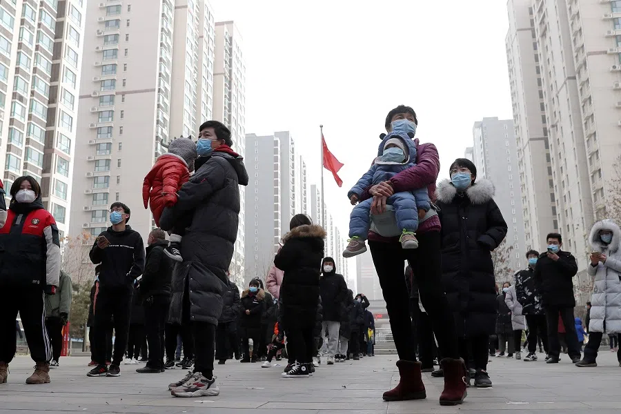 People practise social distancing as they line up for a second round of citywide nucleic acid testing at a residential compound, following new cases of the Covid-19 coronavirus in Shijiazhuang, Hebei province, China, 12 January 2021. (China Daily via Reuters)