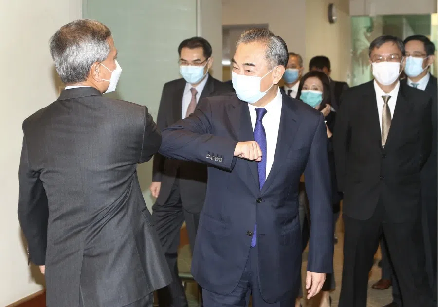 Chinese Foreign Minister Wang Yi (right) meets the Singapore Minister for Foreign Affairs Vivian Balakrishnan (left) at Changi VIP Complex, 13 October 2020. (SPH)