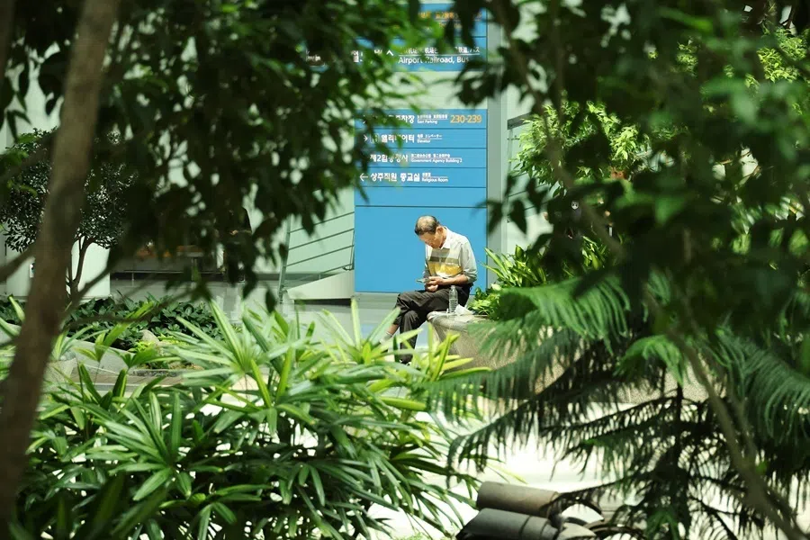 An elderly man uses his mobile phone as he spends time at the Incheon International Airport in Incheon, South Korea, on 7 August 2026.