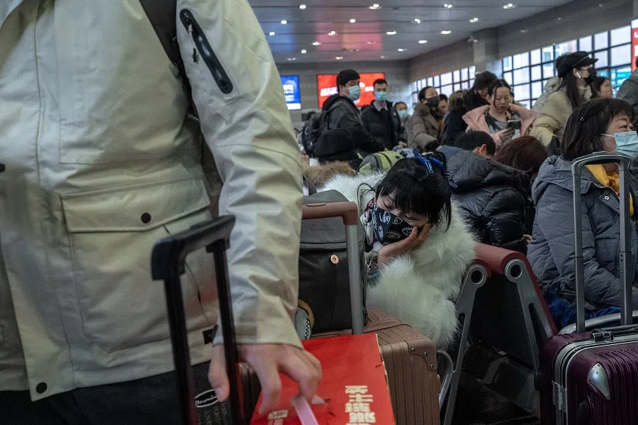 Sister Chen snoozes while waiting for her train home at Beijing West railway station.