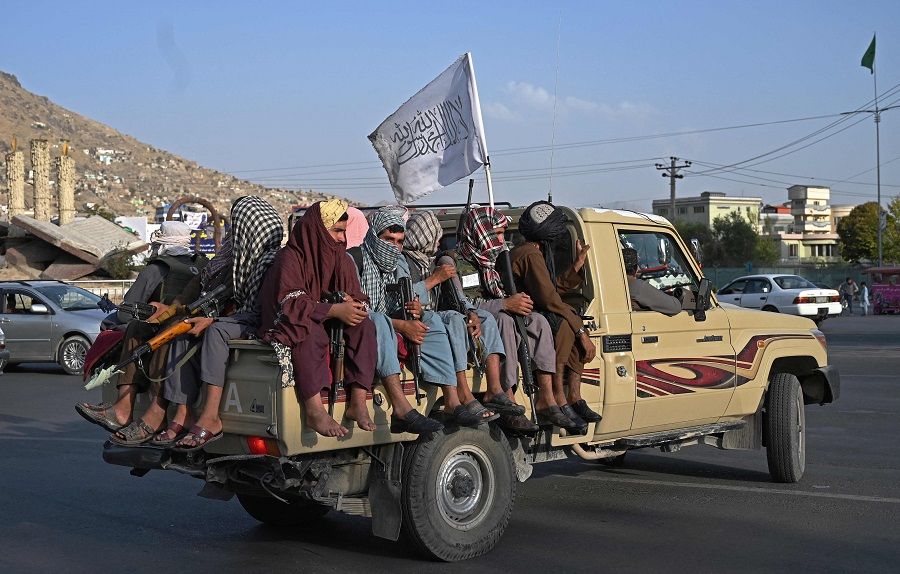 Taliban fighters in a vehicle patrol the streets of Kabul, Afghanistan, on 23 August 2021 as in the capital, the Taliban have enforced some sense of calm in a city long marred by violent crime, with their armed forces patrolling the streets and manning checkpoints. (Wakil Kohsar/AFP)