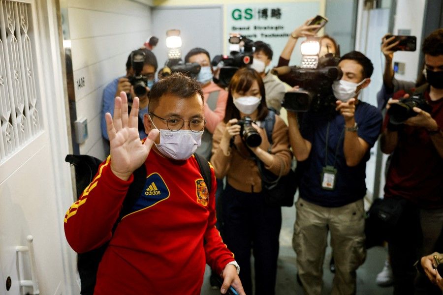 Ronson Chan, Stand News deputy assignment editor and Chairman of Hong Kong Journalists Association, waves to the media as he leaves the Stand News office, in Hong Kong, China, 29 December 2021. (Tyrone Siu/Reuters)