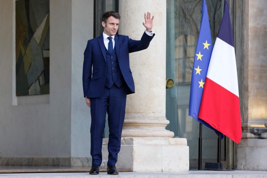 French President Emmanuel Macron waves at the Elysee Palace in Paris on 28 February 2022. (Ludovic Marin/AFP)