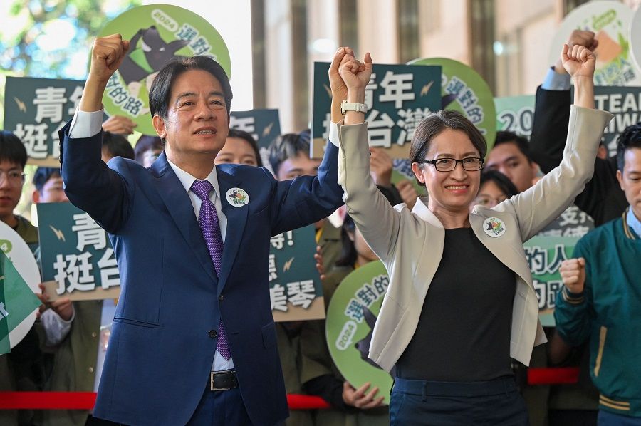 Taiwan presidential candidate Lai Ching-te (left) and his running mate Hsiao Bi-khim (right), from the ruling Democratic Progressive Party (DPP), gesture in front of supporters after they registered running for the 2024 presidential election in Taipei on 21 November 2023. (Sam Yeh/AFP)