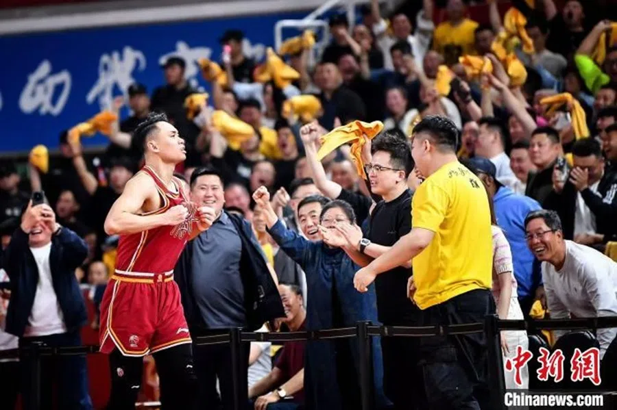 A Shanxi Loongs player and Shanxi Loongs fans celebrate their win over the Guangdong Southern Tigers on 17 April 2025. (Sports China/Facebook)