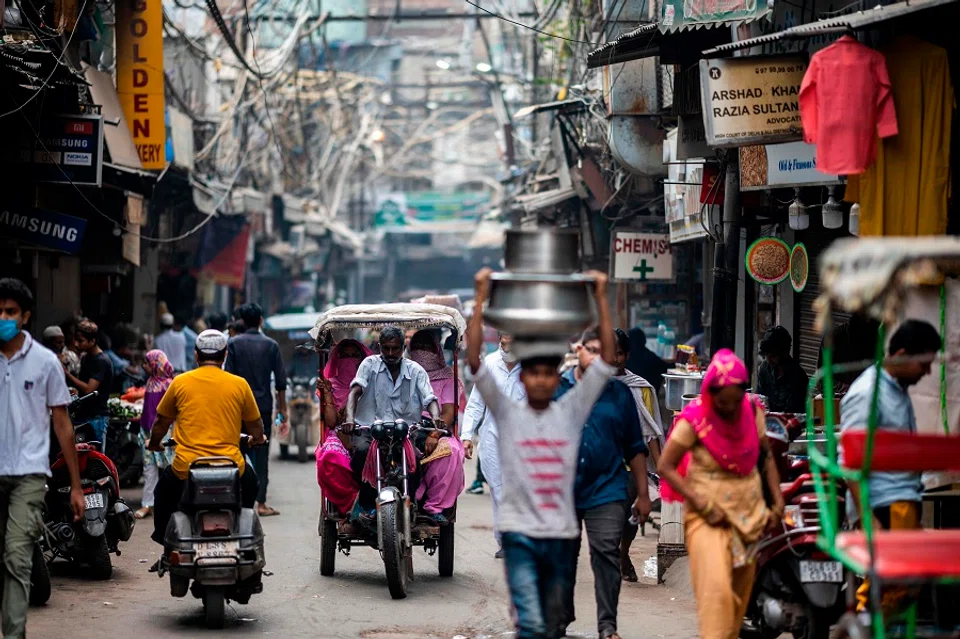 An electric-rickshaw transports passengers along a street in the old quarters of New Delhi on 15 September 2020. (Jewel Samad/AFP)