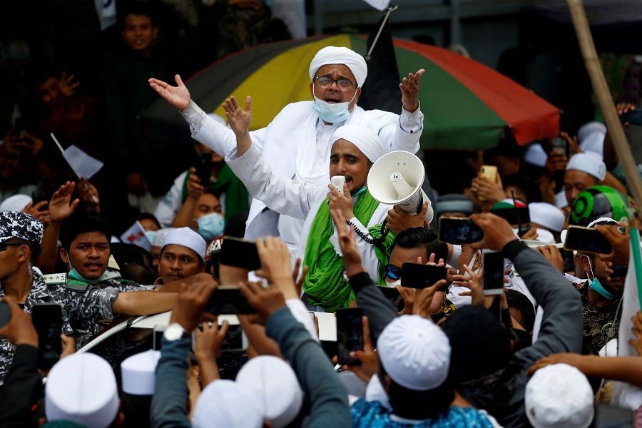 Rizieq Shihab (man with mask over chin), the leader of Indonesia's Islamic Defenders Front (FPI), is greeted by supporters at Tanah Abang, Jakarta, Indonesia, 10 November 2020. (Ajeng Dinar Ulfiana/File Photo/Reuters)