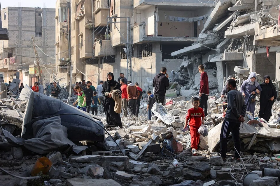 Palestinians walk amid the destruction following an Israeli strike in Jabalia in the northern Gaza Strip on 10 November 2024. Israel’s military has been conducting a sweeping air and ground assault in northern Gaza since 6 October 2024, particularly around Jabalia, Beit Lahia and Beit Hanoun, saying it aims to prevent Hamas regrouping. (Omar Al-Qattaa/AFP)