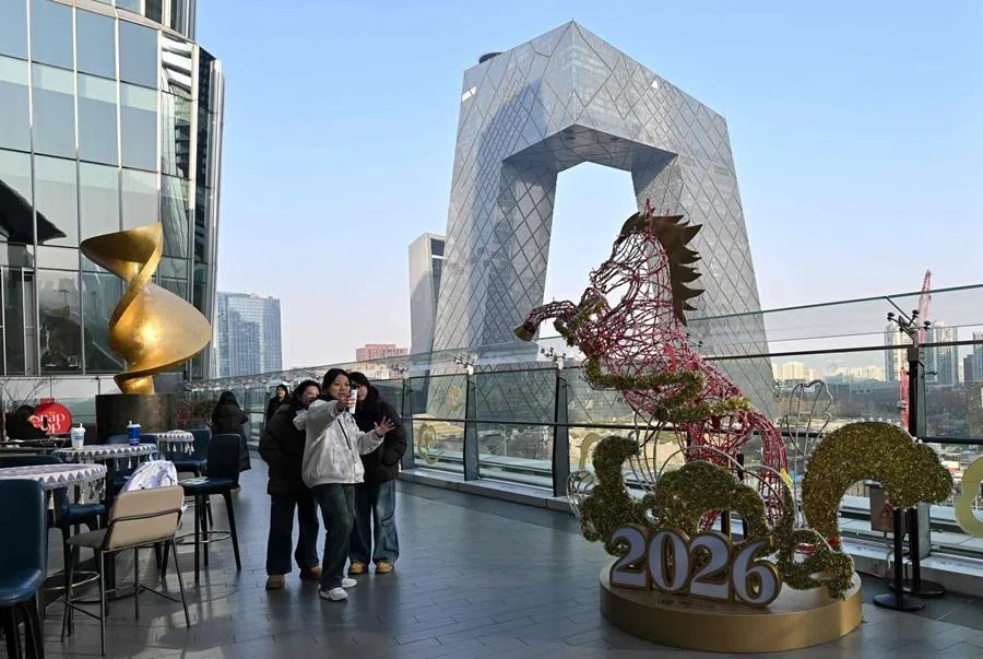 People at a shopping mall in Beijing on 14 January 2026. (Adek Berry/AFP)
