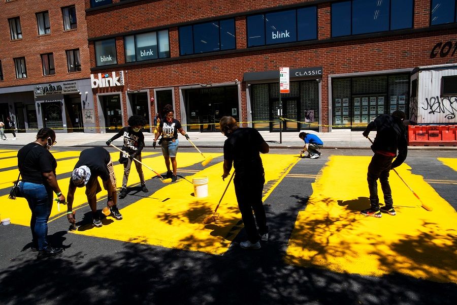 People paint a 'Black Lives Matter' mural on the street as a protest against racial inequality in the aftermath of the death of George Floyd in Minneapolis police custody, in Brooklyn, New York City, US, on 14 June 2020. (Eduardo Munoz/Reuters)