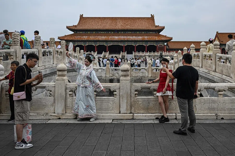 People pose for photos inside the Forbidden City in Beijing on 10 September 2025. (Jade Gao/AFP)