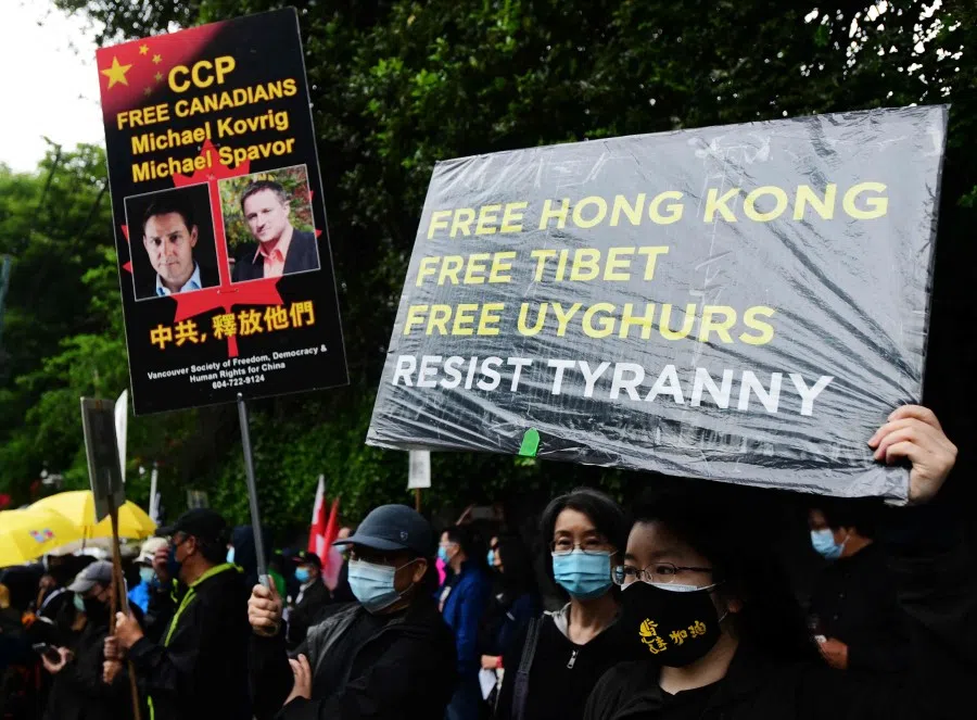 People attend a vigil commemorating the 32nd anniversary of the 1989 Tiananmen square pro-democracy protests and crackdown outside of the Chinese consulate in Vancouver, British Columbia, Canada on 4 June 2021. (Don MacKinnon/AFP)