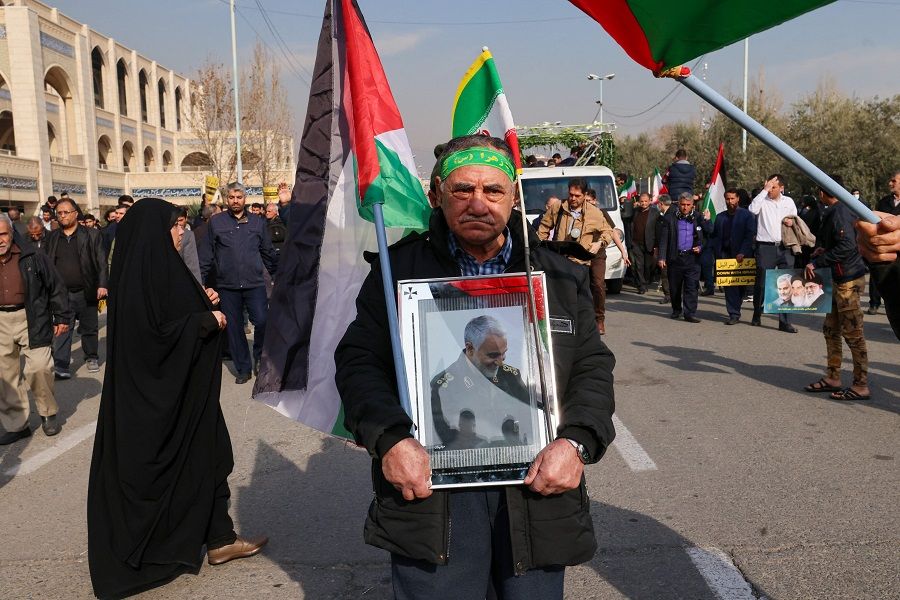 A man holds a portrait of slain Iranian commander Qasem Soleimani on 5 January 2024 in the Iranian capital Tehran. (Atta Kenare/AFP)