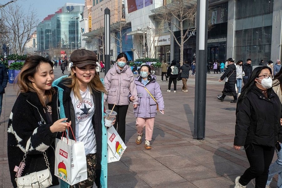 Pedestrians in the Wangfujing shopping area in Beijing, China, on 10 February 2023. (Bloomberg)