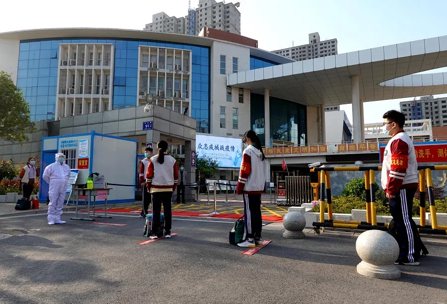 Students wait in line as they practise social distancing on the first day of returning to school at a secondary school in Zhengzhou, Henan province, China, 13 April 2020. (CNS photo via Reuters)
