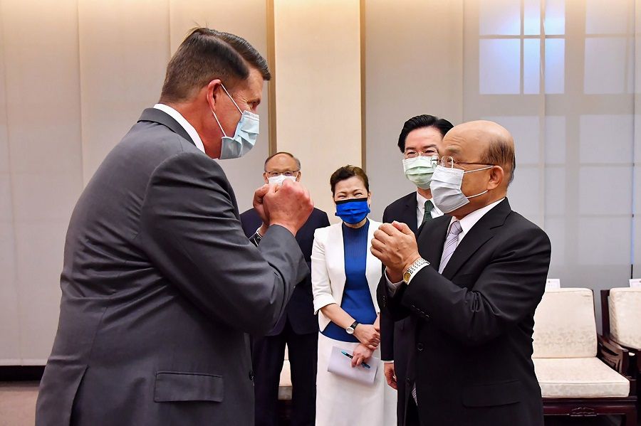 This handout picture taken and released by Taiwan's Executive Yuan on 18 September 2020 shows US Undersecretary of State Keith Krach (left), greeting Taiwan Premier Su Tseng-chang (right) at the Executive Yuan in Taipei. (Handout/Taiwan Executive Yuan/AFP)