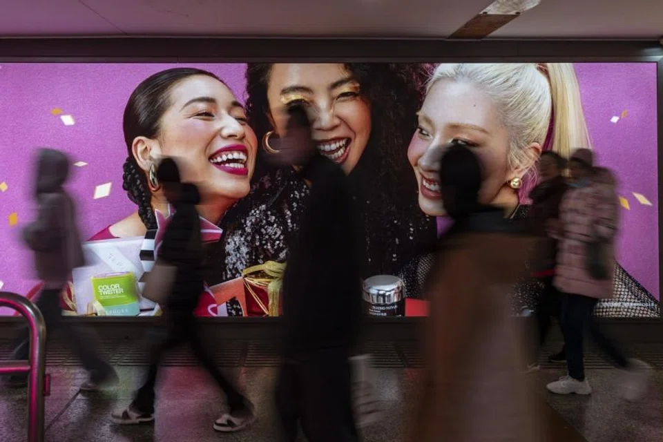 Pedestrians pass an advertisement in the Nanjing East Road shopping area in Shanghai, China, on 19 February 2026. (Qilai Shen/Bloomberg)