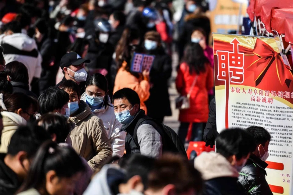 People attend a job fair in Fuyang in China's eastern Anhui province on 29 January 2023. (AFP)