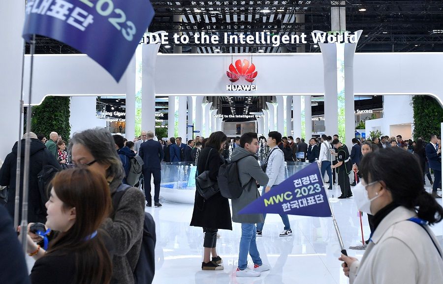Visitors walk next to Chinese manufacturer Huawei's stand at the Mobile World Congress, the telecom industry's biggest annual gathering, in Barcelona, Spain, on 28 February 2023. (Pau Barrena/AFP)