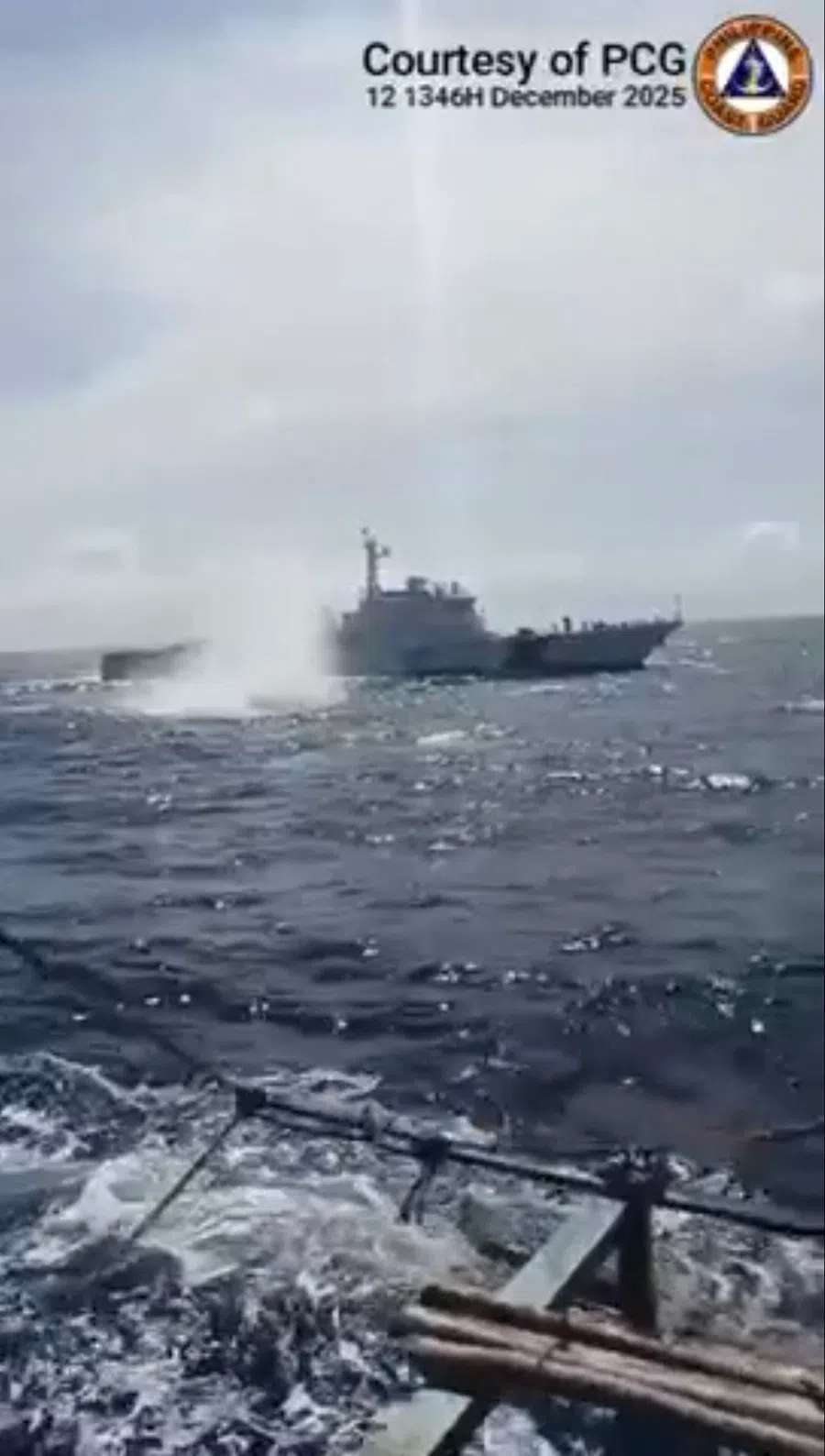 This frame grab from the handout video of the Philippine Coast Guard taken and received on 13 December 2025, shows China Coast Guard deploying water cannon towards a Philippine fishing boat near Sabina Shoal in the South China Sea. (Handout/Philippine Coast Guard/AFP)