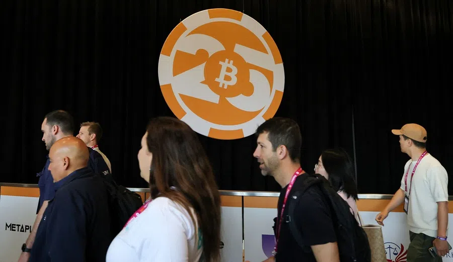 Attendees walk by a logo at the Bitcoin Conference on 28 May 2025, in Las Vegas, Nevada, US. (Ethan Miller/Getty Images/AFP)