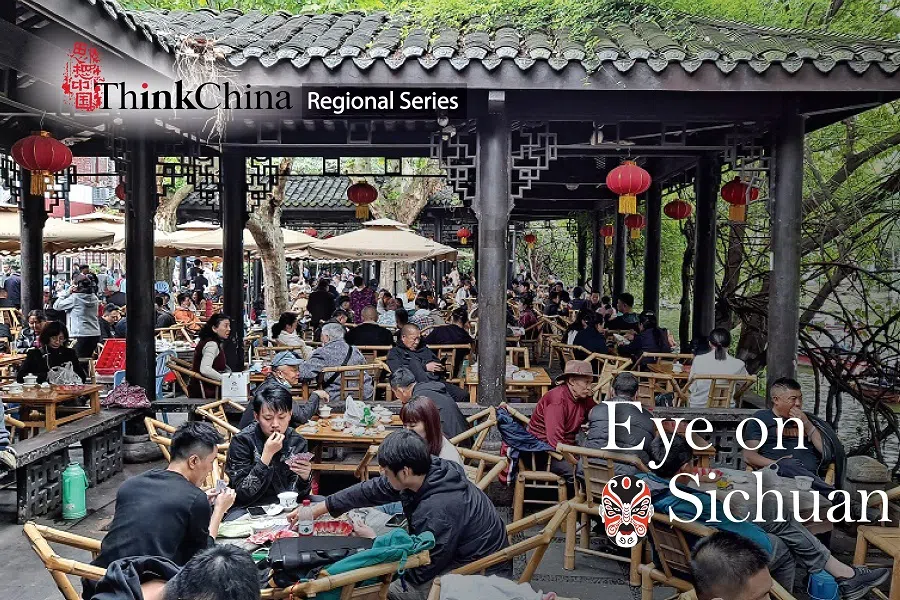 ​People drinking tea and chatting in a teahouse at People’s Park in Chengdu.
