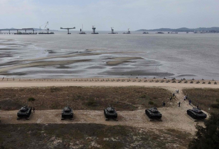 This photo taken on 20 October 2020 shows an aerial view of anti-landing spikes and retired tanks placed along the coast of Taiwan's Kinmen islands, which lie just 3.2 km (two miles) from the mainland China coast (in background) in the Taiwan Strait. - The tank traps on the beaches of Kinmen Island are a stark reminder that Taiwan lives under the constant threat of a Chinese invasion -- and fears of a conflict breaking out are now at their highest in decades. (Sam Yeh/AFP)