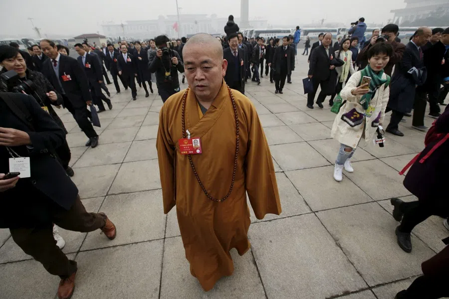 Buddhist abbot Shi Yongxin, a delegate of the National People’s Congress (NPC), walks towards the Great Hall of the People for a plenary meeting of the NPC, China’s parliament, in Beijing, China, on 4 March 2016. (Jason Lee/Reuters)