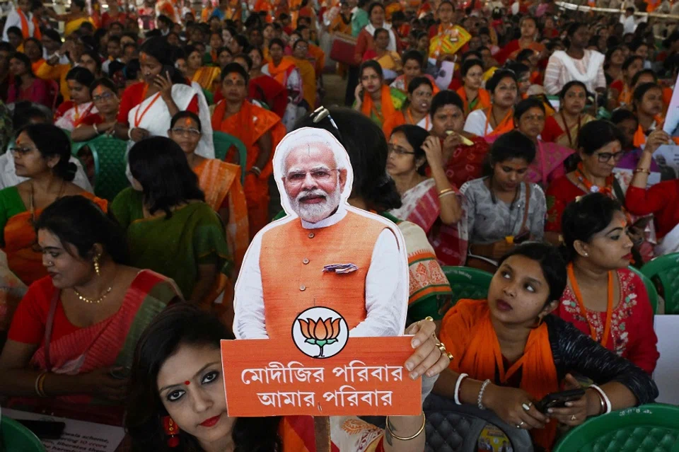 A Bhartiya Janata Party (BJP) supporter holds a cut out picture of Indian Prime Minister Narendra Modi during a public meeting addressed by Modi in Barasat on the outskirts of of Kolkata on 6 March 2024. (Dibyangshu Sarkar/AFP)
